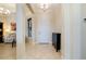 Inviting foyer with tile flooring, adjacent sitting room, and a storage cabinet near the entrance at 10742 Ironbridge Dr, Venice, FL 34293