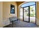 Cozy front porch featuring paver flooring, a decorative bench, and a secure screened entrance at 10742 Ironbridge Dr, Venice, FL 34293