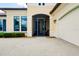 Inviting front entrance with screened-in porch and paver flooring, complemented by an attached garage at 10742 Ironbridge Dr, Venice, FL 34293