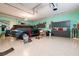 Spacious three car garage with epoxy flooring and ample storage, and large SUV parked inside at 10742 Ironbridge Dr, Venice, FL 34293