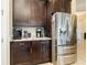 Modern kitchen features stainless steel refrigerator and granite countertops for a luxurious feel at 10742 Ironbridge Dr, Venice, FL 34293