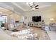 Inviting living room featuring a large sofa, mirrored console, and floral accents at 10742 Ironbridge Dr, Venice, FL 34293