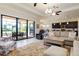 Spacious living room with an open layout, tile floors, and access to the outdoor patio at 10742 Ironbridge Dr, Venice, FL 34293