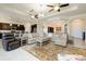 Open concept living room with high ceilings, ceiling fans, and a view into the kitchen at 10742 Ironbridge Dr, Venice, FL 34293