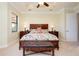 Serene main bedroom with large bed, neutral walls, and a tray ceiling at 10742 Ironbridge Dr, Venice, FL 34293