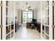 Home office with French doors, ceiling fan, and abundant natural light at 10742 Ironbridge Dr, Venice, FL 34293