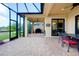 Screened lanai with brick pavers and an outdoor dining area perfect for entertaining guests at 10742 Ironbridge Dr, Venice, FL 34293