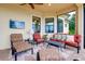 Spacious covered patio featuring a ceiling fan, comfortable seating, and open views of the backyard at 10742 Ironbridge Dr, Venice, FL 34293