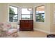 Bright sitting area features an upholstered armchair and a chest of drawers at 10742 Ironbridge Dr, Venice, FL 34293