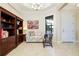 Bright sitting room with tile flooring, decorated with elegant furniture and ample natural light at 10742 Ironbridge Dr, Venice, FL 34293