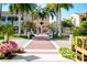 Beautiful street view with blooming flowers, tall palm trees, and sidewalks, perfect for a relaxing stroll at 10742 Ironbridge Dr, Venice, FL 34293