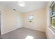 Bright bedroom features wood-look floors, white door, and windows with natural light at 1075 Falcon Rd, Venice, FL 34293