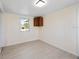 Bedroom with wood-look floors, a window and overhead lighting at 1075 Falcon Rd, Venice, FL 34293