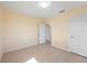 Cozy bedroom features light wood floors, white doors, and neutral walls at 1075 Falcon Rd, Venice, FL 34293