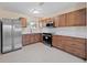 Updated kitchen with stainless steel appliances, ample cabinet space, and stylish countertops at 1075 Falcon Rd, Venice, FL 34293