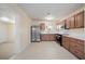 Well-designed kitchen featuring stainless appliances, wooden cabinetry, and smooth countertops at 1075 Falcon Rd, Venice, FL 34293