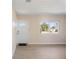 Bright living room boasts beautiful light-colored floors and a refreshing view from the windows at 1075 Falcon Rd, Venice, FL 34293