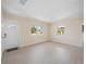 Bright living room boasts beautiful light-colored floors and a refreshing view from the windows at 1075 Falcon Rd, Venice, FL 34293