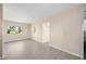Bright living room features neutral paint, wood-look floors and large windows at 1075 Falcon Rd, Venice, FL 34293