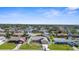 A charming home is seen from the air, in a nice neighborhood with green lawns and beautiful landscaping at 1087 Piedmont Rd, Venice, FL 34293