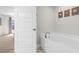 Bright bathroom features a soaking tub and beach-themed decor at 1087 Piedmont Rd, Venice, FL 34293
