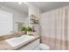Bathroom with a single sink vanity, mirror, and shower with a curtain at 1087 Piedmont Rd, Venice, FL 34293