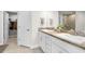 Bathroom with dual sinks, granite countertops, and a walk-in closet at 1087 Piedmont Rd, Venice, FL 34293