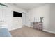 Bedroom featuring neutral walls, carpet, a tv, and a dresser at 1087 Piedmont Rd, Venice, FL 34293