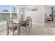 Cozy dining area bathed in natural light, with a view of the backyard, and access to the kitchen and other rooms at 1087 Piedmont Rd, Venice, FL 34293