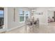 Cozy dining area near large windows offers a view of the backyard and has easy access to the kitchen at 1087 Piedmont Rd, Venice, FL 34293