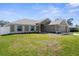 Charming home boasting a two-car garage, lush green lawn, and meticulously maintained landscaping at 1087 Piedmont Rd, Venice, FL 34293