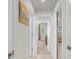 Hallway leading to living spaces, offering natural light and neutral decor at 1087 Piedmont Rd, Venice, FL 34293