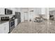 Bright kitchen features stainless steel appliances, granite counters, and white cabinetry at 1087 Piedmont Rd, Venice, FL 34293