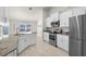 Open kitchen boasts stainless steel appliances, granite counters, and a breakfast nook at 1087 Piedmont Rd, Venice, FL 34293