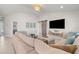 Spacious living room with neutral tones features vaulted ceiling, a barn door, and a comfortable sectional sofa at 1087 Piedmont Rd, Venice, FL 34293