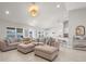 Large living room features a sectional sofa, and is open to the kitchen and dining areas for easy entertaining at 1087 Piedmont Rd, Venice, FL 34293