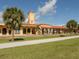 Charming train station with Spanish-style architecture, featuring a terracotta roof and palm trees at 1100 Capri Isles Blvd # 423, Venice, FL 34292