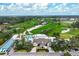 Stunning aerial view of the golf course and clubhouse, complete with lush green fairways and mature trees at 11172 Mc Dermott Ct, Englewood, FL 34223