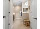 Bright bathroom featuring tile floors, a glass-enclosed shower, and a wooden bench at 11172 Mc Dermott Ct, Englewood, FL 34223