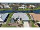 Scenic aerial view of a well-maintained home surrounded by lush greenery and a tranquil lake at 1125 Deardon Dr, Venice, FL 34292