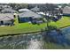 Backyard view of a home with a screened-in pool and patio overlooking a tranquil lake at 1125 Deardon Dr, Venice, FL 34292