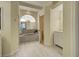 Elegant bathroom featuring a luxurious tub, arched window, and marble countertop vanity at 1125 Deardon Dr, Venice, FL 34292