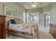 Light and airy bedroom with access to the lanai and pool area, perfect for indoor-outdoor living at 1125 Deardon Dr, Venice, FL 34292