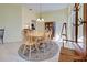 Dining room with neutral walls, decorative rug, chandelier, and several windows at 1125 Deardon Dr, Venice, FL 34292