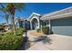 Charming home exterior featuring a two-car garage and neatly landscaped front yard at 1125 Deardon Dr, Venice, FL 34292