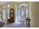 Bright foyer features beautiful front door, neutral walls, and wood-look flooring at 1125 Deardon Dr, Venice, FL 34292