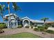 Charming single-story home featuring lush landscaping, palm trees, and a welcoming front entrance at 1125 Deardon Dr, Venice, FL 34292