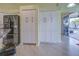 Spacious kitchen area with stainless steel refrigerator and ample white cabinetry at 1125 Deardon Dr, Venice, FL 34292