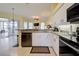 Open concept kitchen with granite counters, stainless steel appliances, and bar seating at 1125 Deardon Dr, Venice, FL 34292