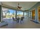 Relaxing lanai offers a dining set, ceiling fans, and pool views for serene outdoor enjoyment at 1125 Deardon Dr, Venice, FL 34292